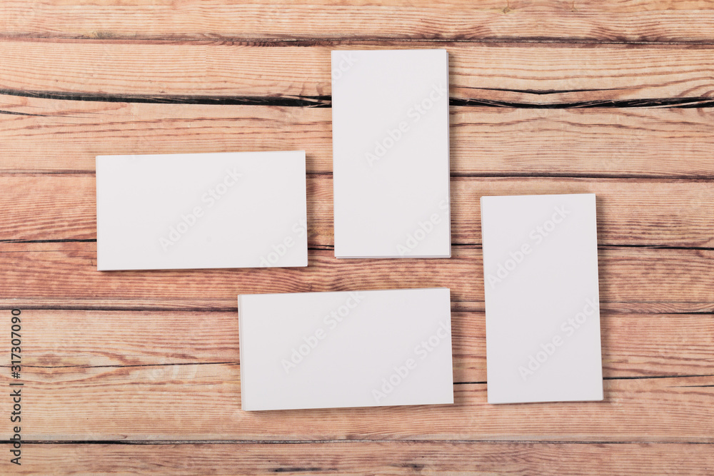 Photo of empty business cards on a light natural wooden background .. Template for identifier. Photo of empty business cards on a light natural wooden background .. Template for identifier.