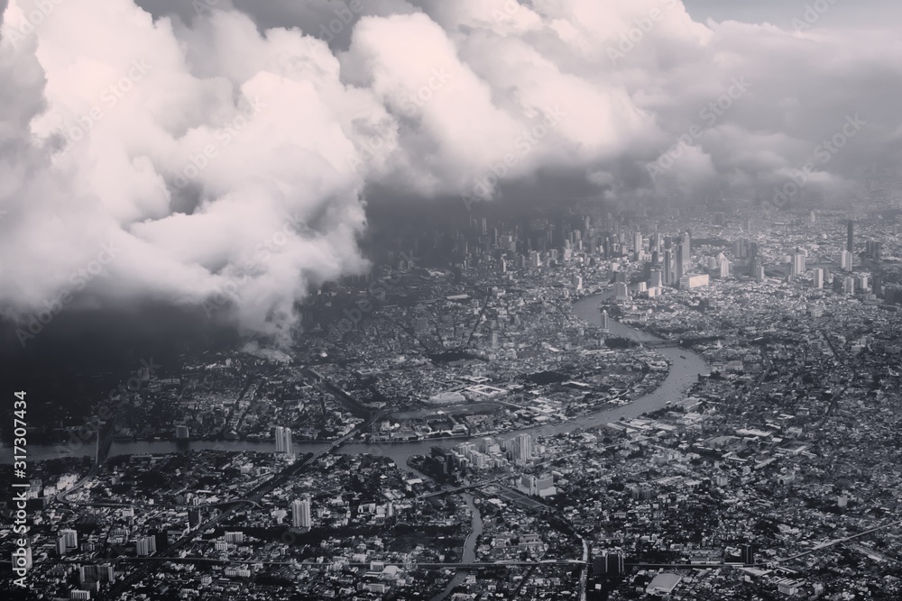 Heavy storm clouds looming over Bangkok, Thailand. Black and white color toning vintage effect.