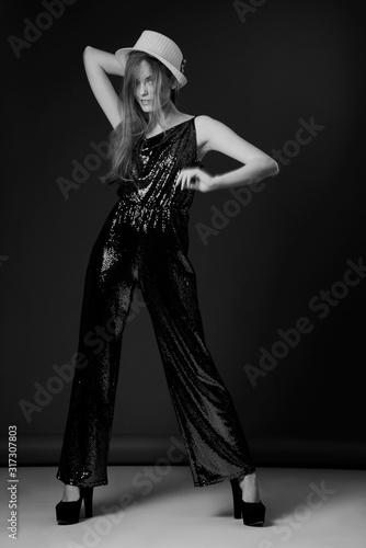 fashion model posing in sequin jumpsuit, black and white photo