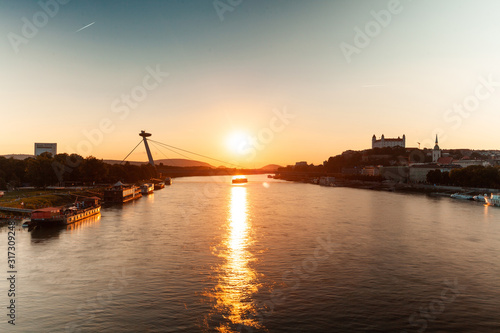 View of UFO Bridge over Danube River during sunset, Bratislava, Slovakia photo