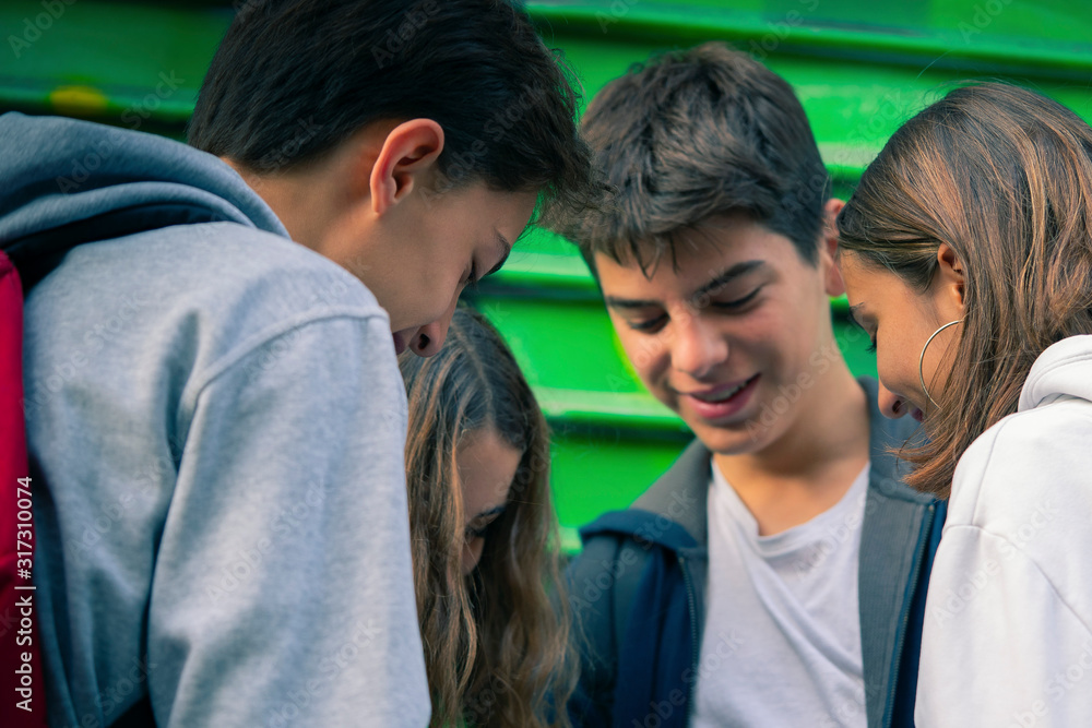 Smiling teenage friends standing outdoors Smiling teenage friends standing outdoors