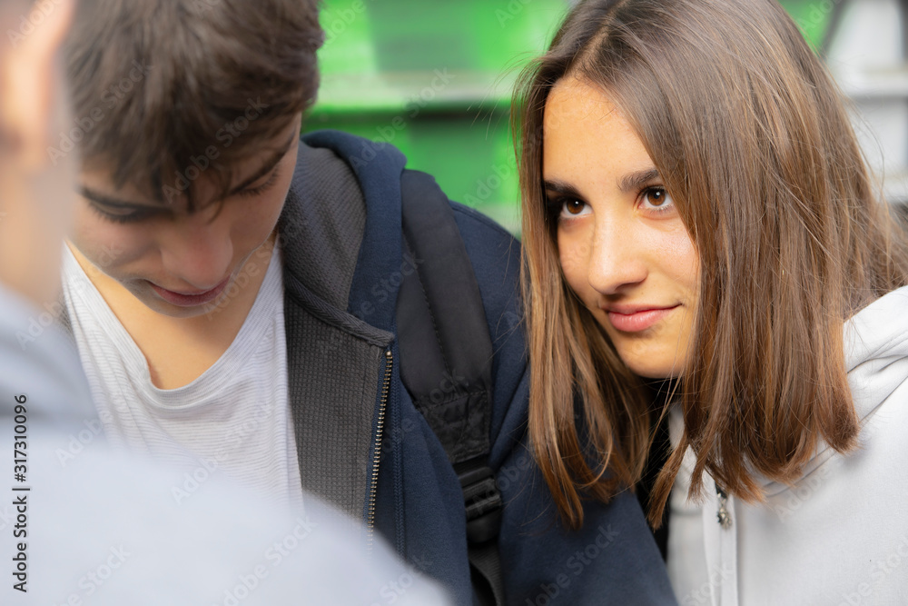 Close-up of smiling teenage girl looking at her friend Close-up of smiling teenage girl looking at her friend
