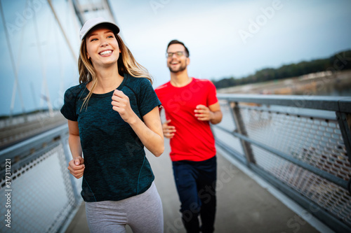 Beautiful couple running in nature living healthy