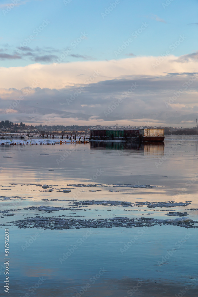 Beautiful View of Fraser River in the City during a cold and icy winter sunset. Taken in New Westminster, Vancouver, British Columbia, Canada.