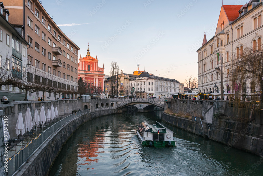 View of a canal in Ljubljana in Slovenia with boat during sunset