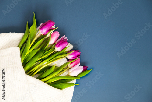 Bouquet of tulips on classic blue background. Holiday concept. Greeting for Women's or Mothers Day, Valentines day photo