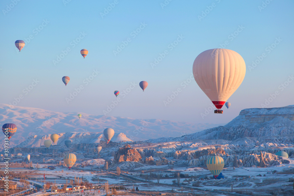 Colorful hot air balloons flying over the famous tourist place Cappadocia