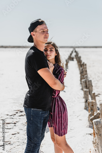 love story in the desert, happy young couple,young people are walking and holding hands,love story in a beautiful place,summer vacation for a young couple,beautifully dressed young people in love,runn photo