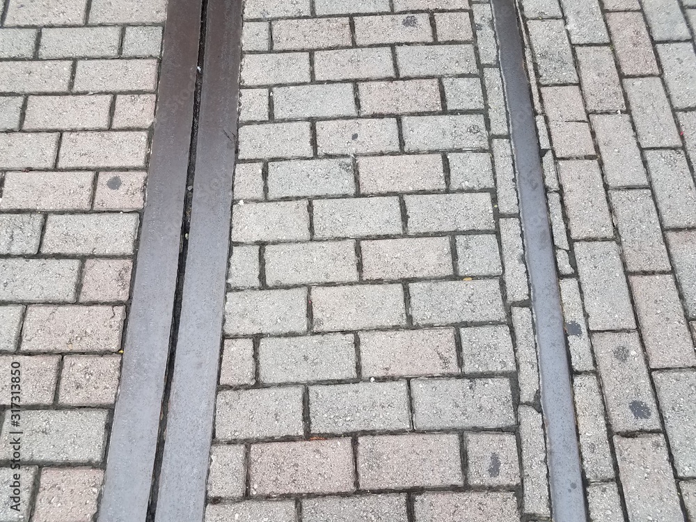 red bricks or ground with metal train track