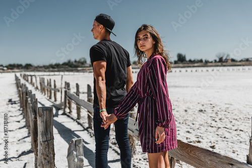 love story in the desert, happy young couple,young people are walking and holding hands,love story in a beautiful place,summer vacation for a young couple,beautifully dressed young people in love,runn photo