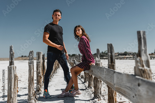 love story in the desert, happy young couple,young people are walking and holding hands,love story in a beautiful place,summer vacation for a young couple,beautifully dressed young people in love,runn photo