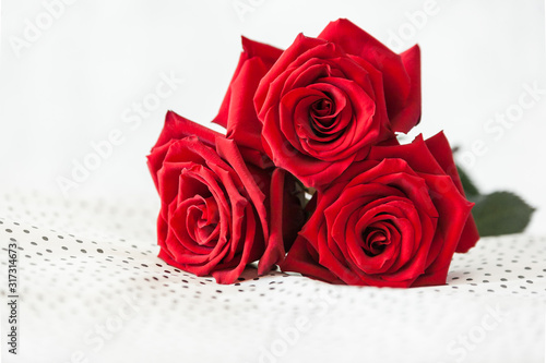 three Red roses on white background as symbol of love on valentine's Day