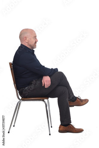 portrait of a man sitting on a chair in white background, profile