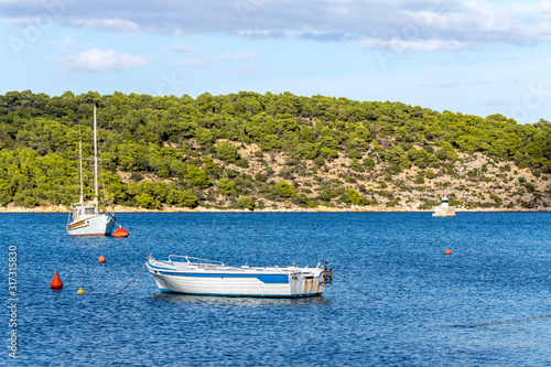 The panoramic views of the sea, the mountains and the moored boats © TETYANA