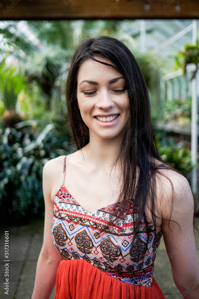Beautiful woman during Spring time in a greenhouse Beautiful woman during Spring time in a greenhouse