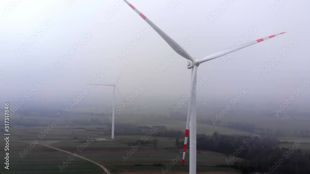 Windmills stirring on a foggy morning at Ostrowiec town Poland, drone shot Windmills stirring on a foggy morning at Ostrowiec town Poland, drone shot