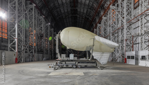 Photos Small blimp on a mooring platform inside a giant airship hangar