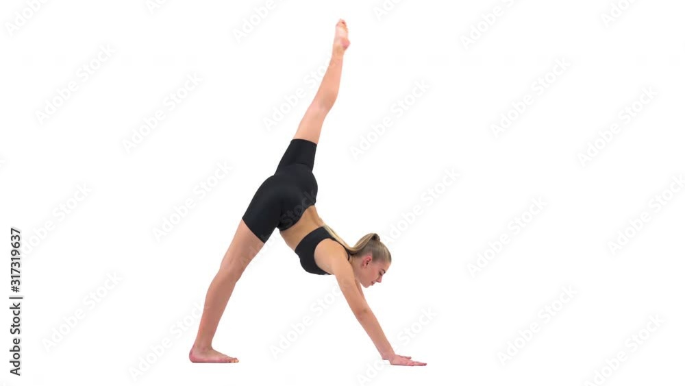 Professional female acrobat in downward facing dog pose (adho mukha svanasana pose) performing stretching exercises