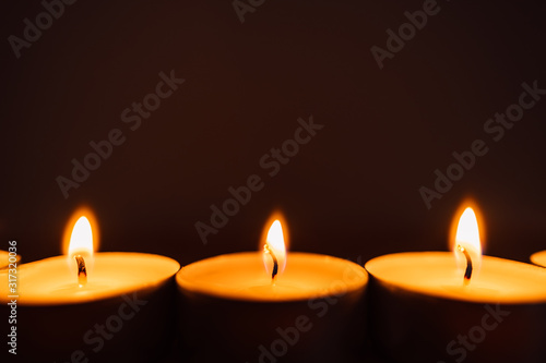 background with burning candles on black background