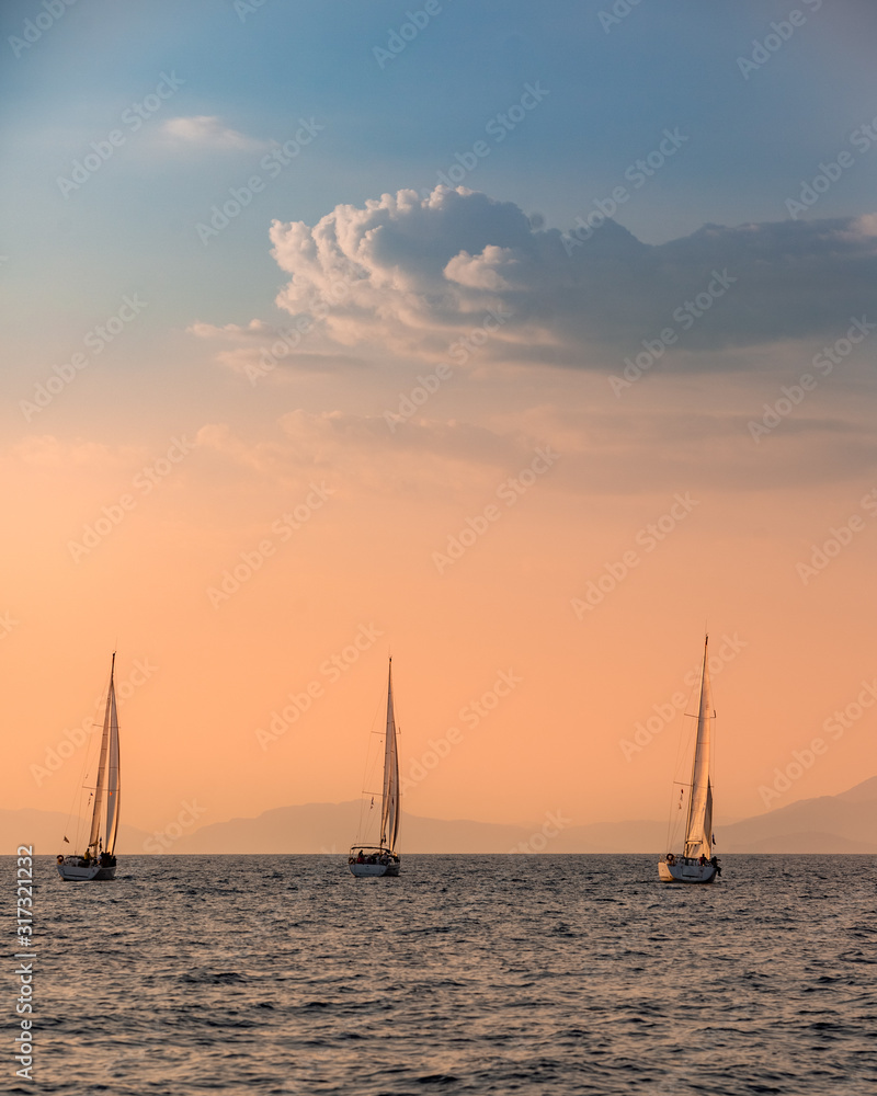 Orange romantic sunset with silhouette of yacht