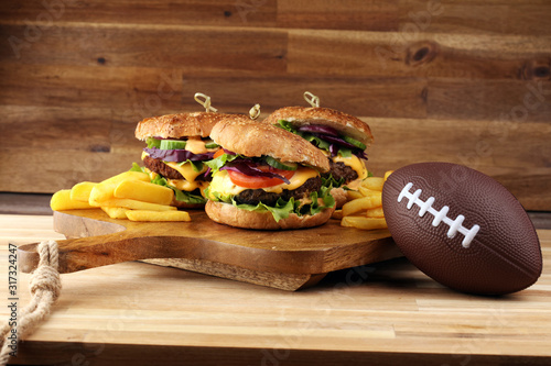 Tasty fresh meat burgers with salad and cheese. Homemade angus burger. Great for Bowl football Game angus burger photo