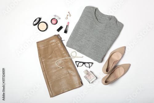 set of fashionable women's clothing and accessories on a white background top view. 