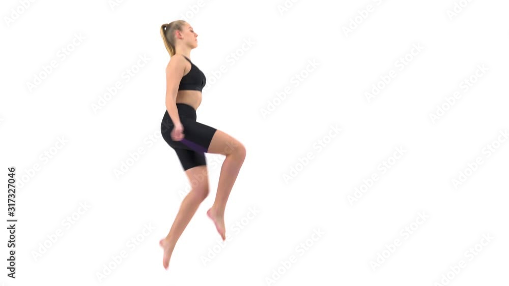 Side view of a professional female gymnast jumping with the rope. Sport and fitness concept. Isolated, on white background Side view of a professional female gymnast jumping with the rope. Sport and fitness concept. Isolated, on white background