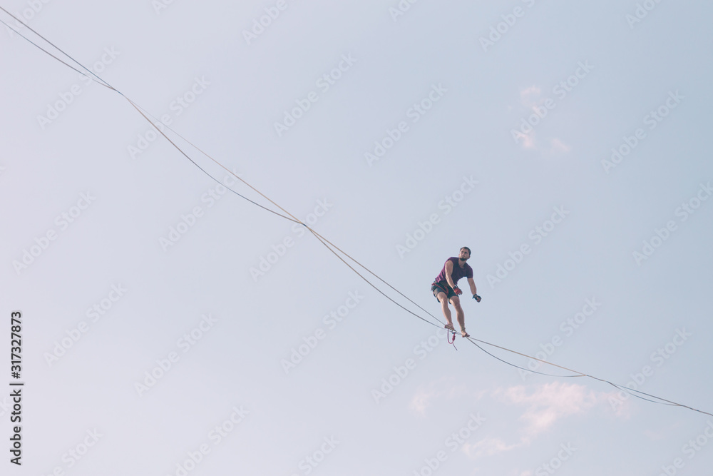 Highliner on the background of blue sky. Highliner on the background of blue sky.