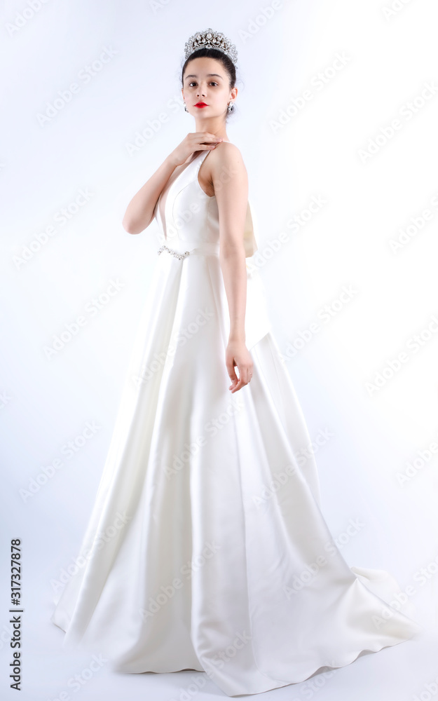 beautiful very young bride in a luxurious wedding dress and tiara beautiful very young bride in a luxurious wedding dress and tiara