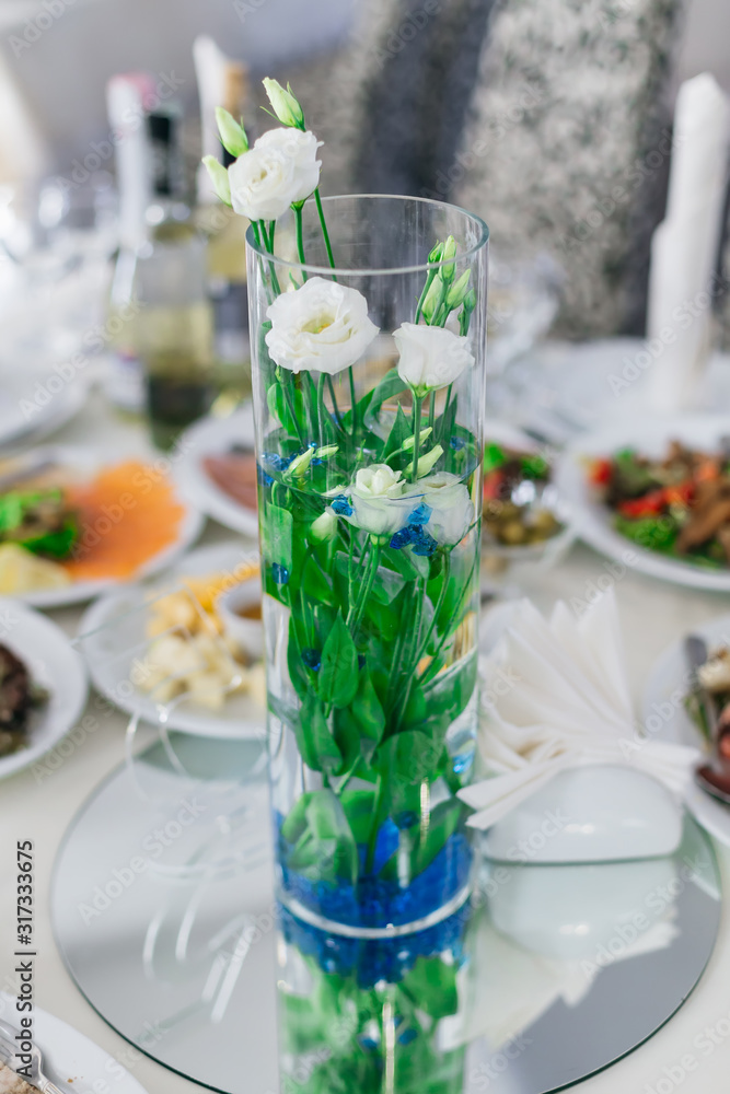 beautiful transparent vase with roses on the table with many dis beautiful transparent vase with roses on the table with many dis