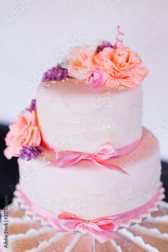 chic wedding cake on a three-tier stand. cake decorated with rib