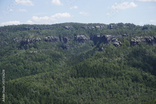 Impressive sandstone rocks peeling out of the forest in the Schrammsteine region