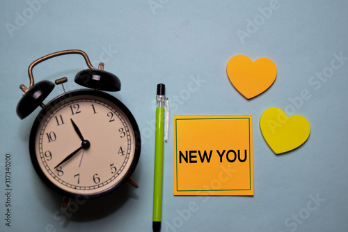 New You write on a sticky note isolated on office desk.