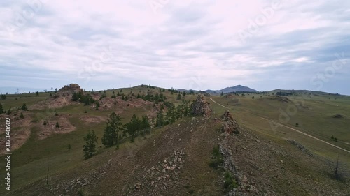 Baikal Valley spirits,Tazheran steppe, stone cliffs on the road. Aerial Summer photo