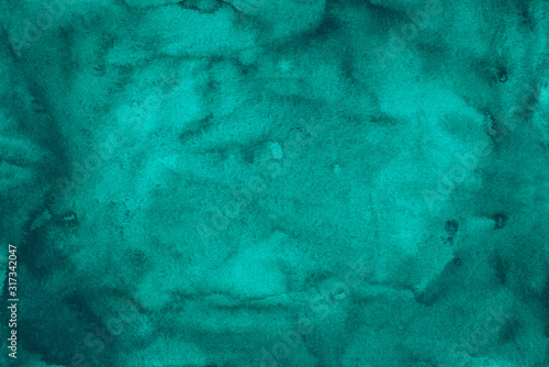 Watercolor deep turquoise blue background texture. Aquarelle abstract sea blue stains on paper backdrop.