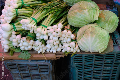 Vegetables on top of a imporvised table as sold at a street market, tianguis, in Mexico, Onions, radish and cabagge photo