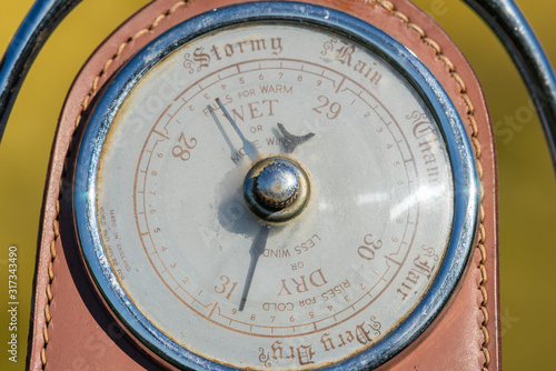 Close up of an antique barometer made out of an old horses stirrup indicating high pressure photo