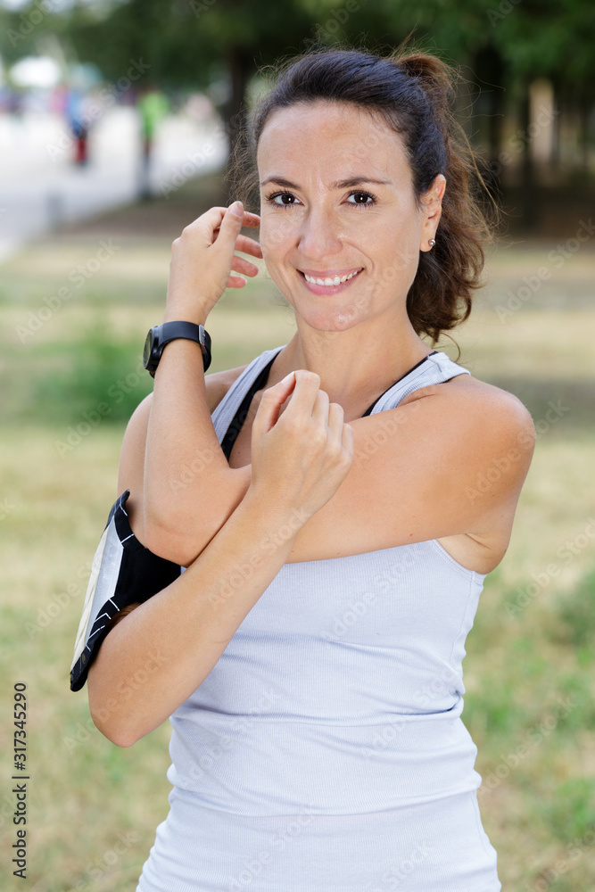 sporty woman enjoying stretching arms outdoors sporty woman enjoying stretching arms outdoors