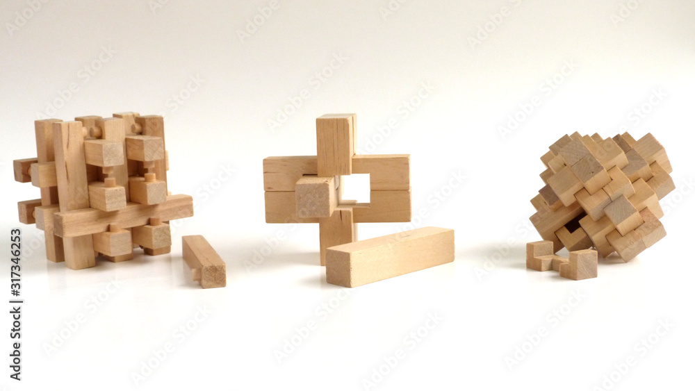Burr Puzzles | Interlocking Puzzles | Close up of Three-Dimensional Wooden Puzzles on a White Background Burr Puzzles | Interlocking Puzzles | Close up of Three-Dimensional Wooden Puzzles on a White Background