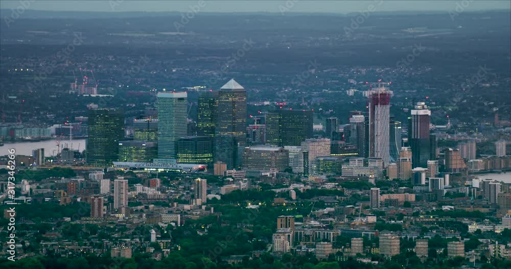 Aerial view of Canary Wharf skyline. London financial district with its modern skyscrapers. River Thames, famous bridges and buildings in the background. England. UK. Shot on Red Weapon 8K. Aerial view of Canary Wharf skyline. London financial district with its modern skyscrapers. River Thames, famous bridges and buildings in the background. England. UK. Shot on Red Weapon 8K.