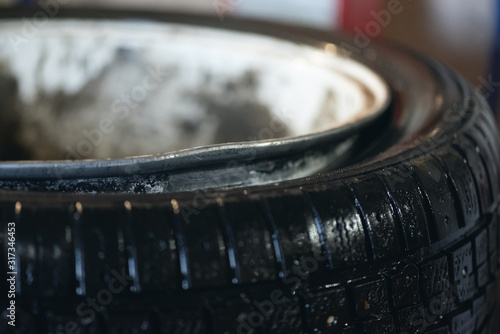 Bent car wheel rim close up background.