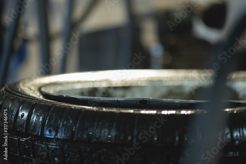 Fotografía Bent car wheel rim close up background.