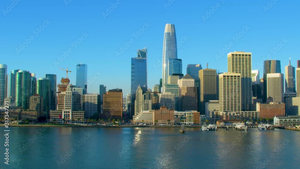 Amazing aerial view of San Francisco skyline. Flyover the Pacific ocean with several ships. Famous skyscrapers over a blue sky. Shot on Red weapon 8K. California, United States. Amazing aerial view of San Francisco skyline. Flyover the Pacific ocean with several ships. Famous skyscrapers over a blue sky. Shot on Red weapon 8K. California, United States.