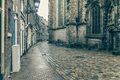 Empty narrow street in old town, medieval buildings, vintage background