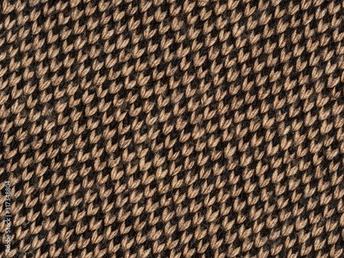 Background is made of knitted fabric brown and black. Chess location diagonally