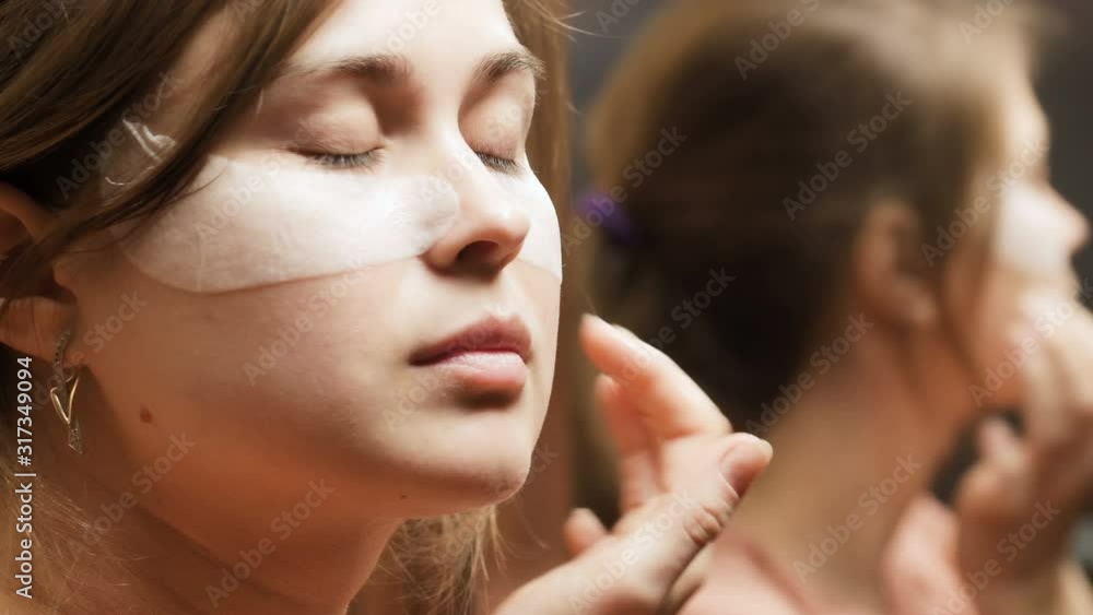 beautiful young woman smoothes patches under her eyes with her fingers, girl takes dermatological skin care, concept female beauty and youth, morning routine beautiful young woman smoothes patches under her eyes with her fingers, girl takes dermatological skin care, concept female beauty and youth, morning routine