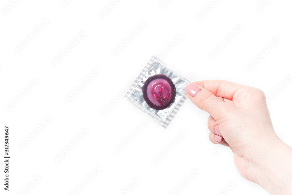 color condom in female hand isolated on a white background color condom in female hand isolated on a white background