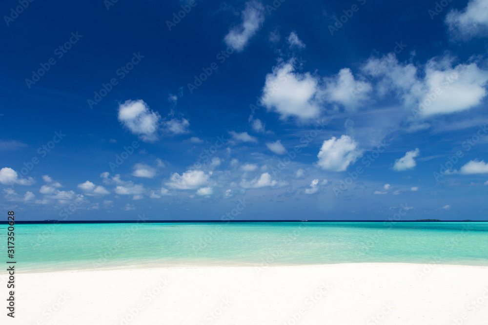 Beautiful beach with white sand. Tropical sea with cloudy blue sky . Amazing beach landscape