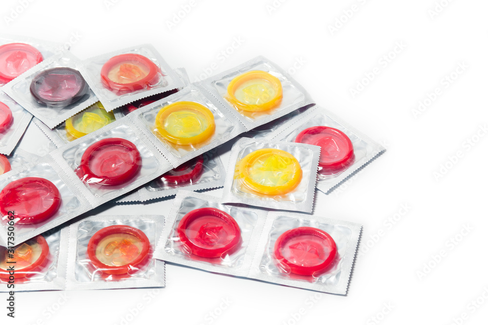 color condom in female hand isolated on a white background color condom in female hand isolated on a white background