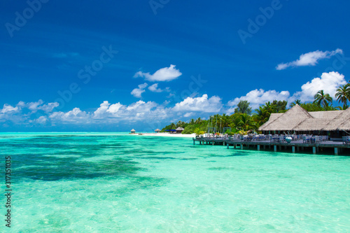 Fototapeta Naklejka Na Ścianę i Meble -  Maldives water bungalows resort at islands beach. Indian Ocean, Maldives. Beautiful sea landscape, luxury resort and  sky. Beach  under wonderful sky